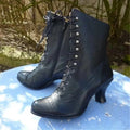Black lace-up platform mid calf boots with side zipper closure and medium heel on white background