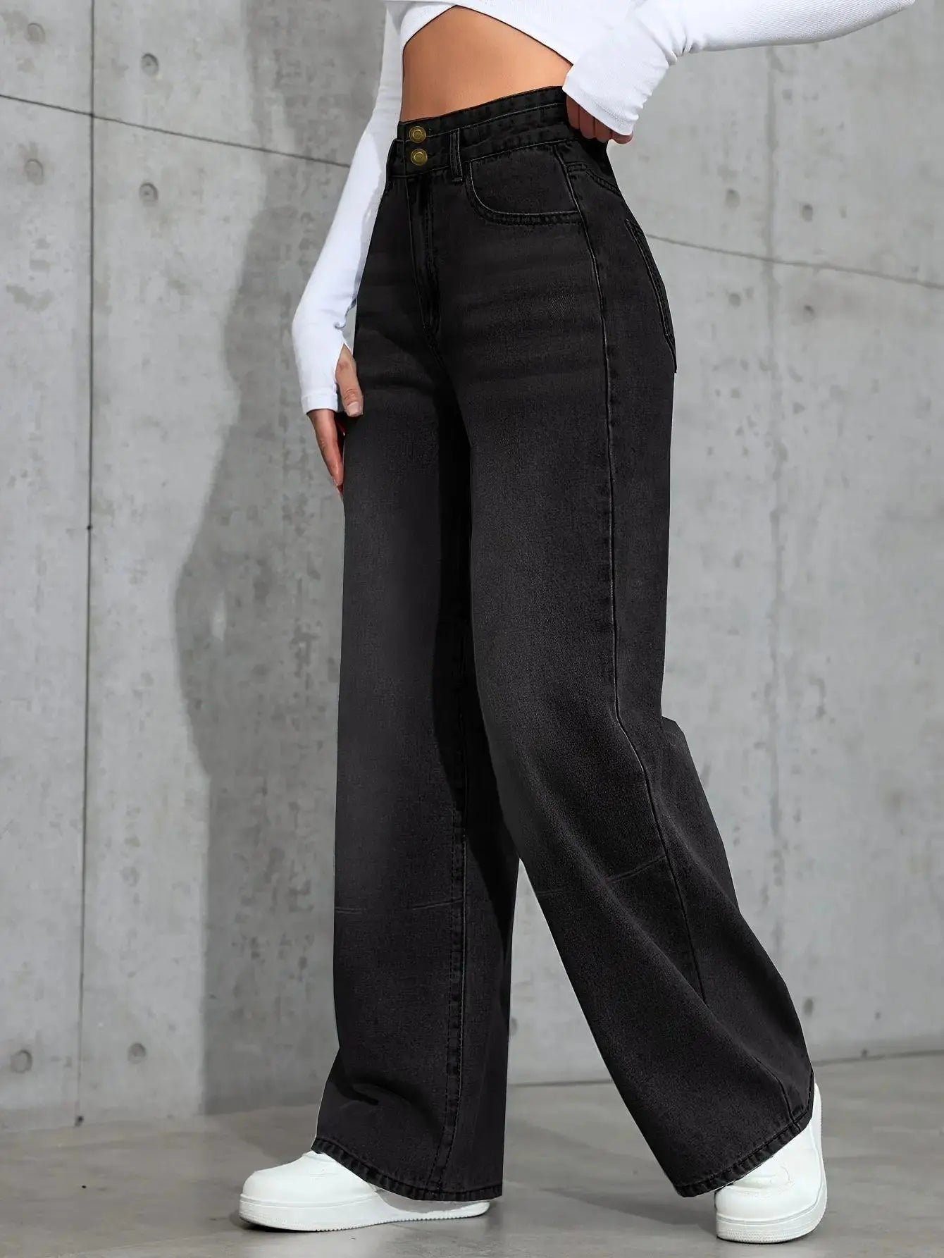 High-waist jeans displayed on a hanger, emphasizing the cotton blend material for all-season wear.