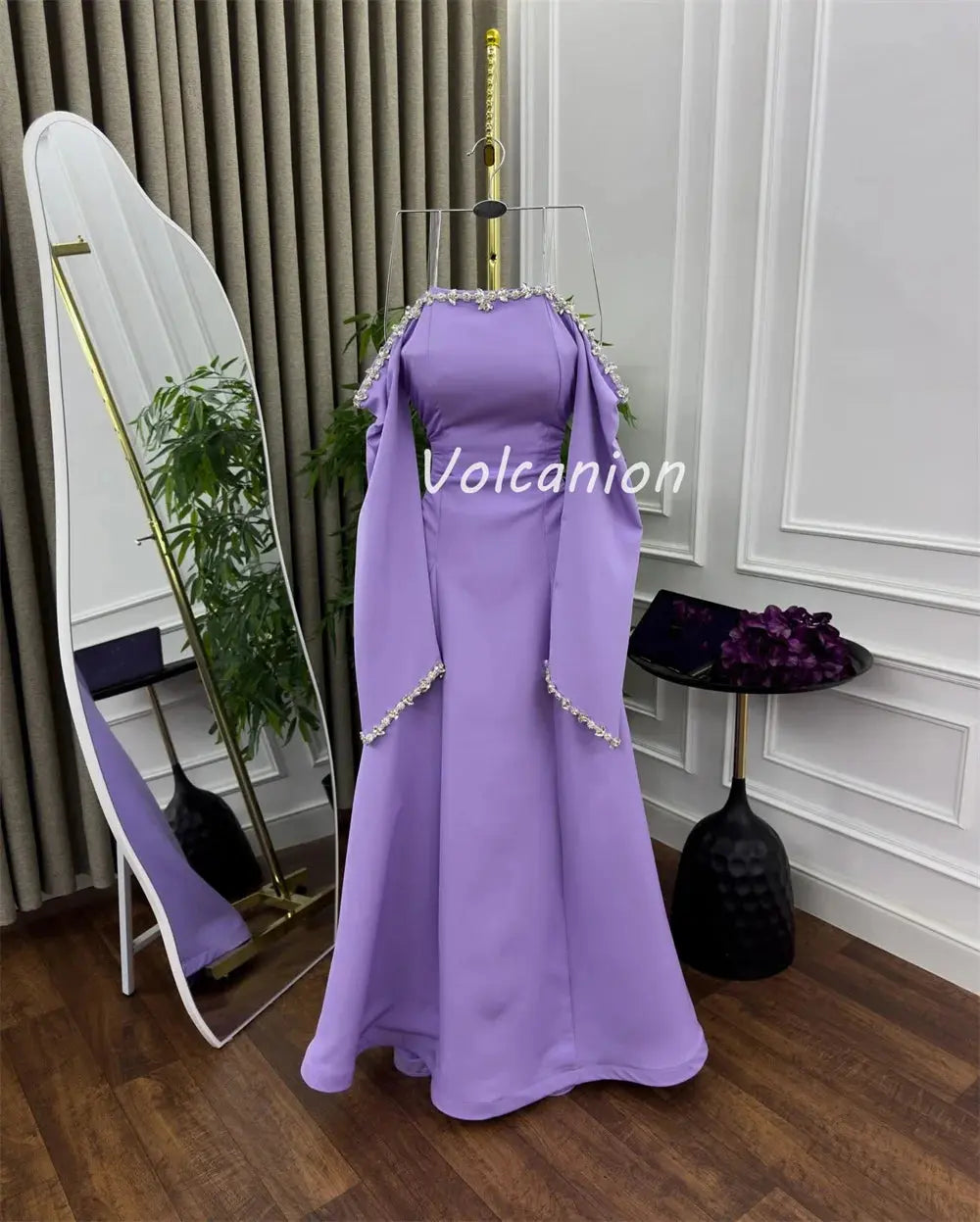 Model wearing the off-shoulder gown, showcasing its stunning silhouette and comfortable jersey fabric in action.