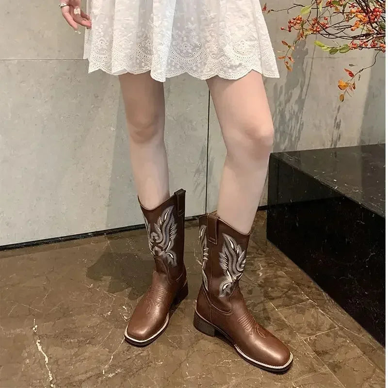 Mid-calf slip-on cowboy boots showcasing traditional Western embroidery on genuine leather
