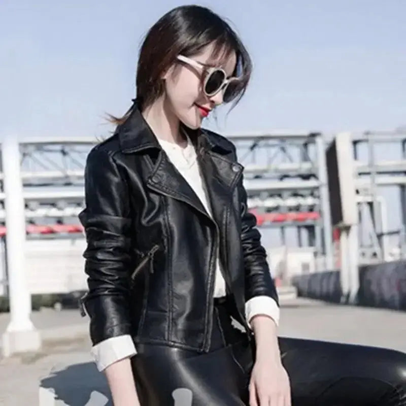 Model wearing the leather jacket in an autumn setting, exuding confidence and effortless style.