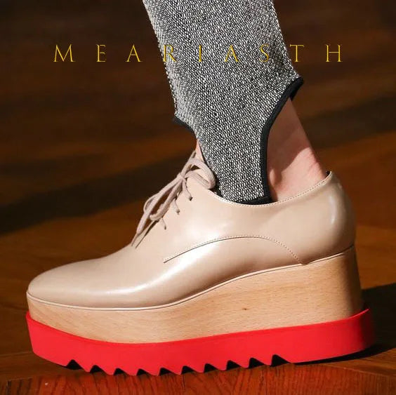 Slip-on leather wedge sneakers featuring waterproof construction and elevated platform