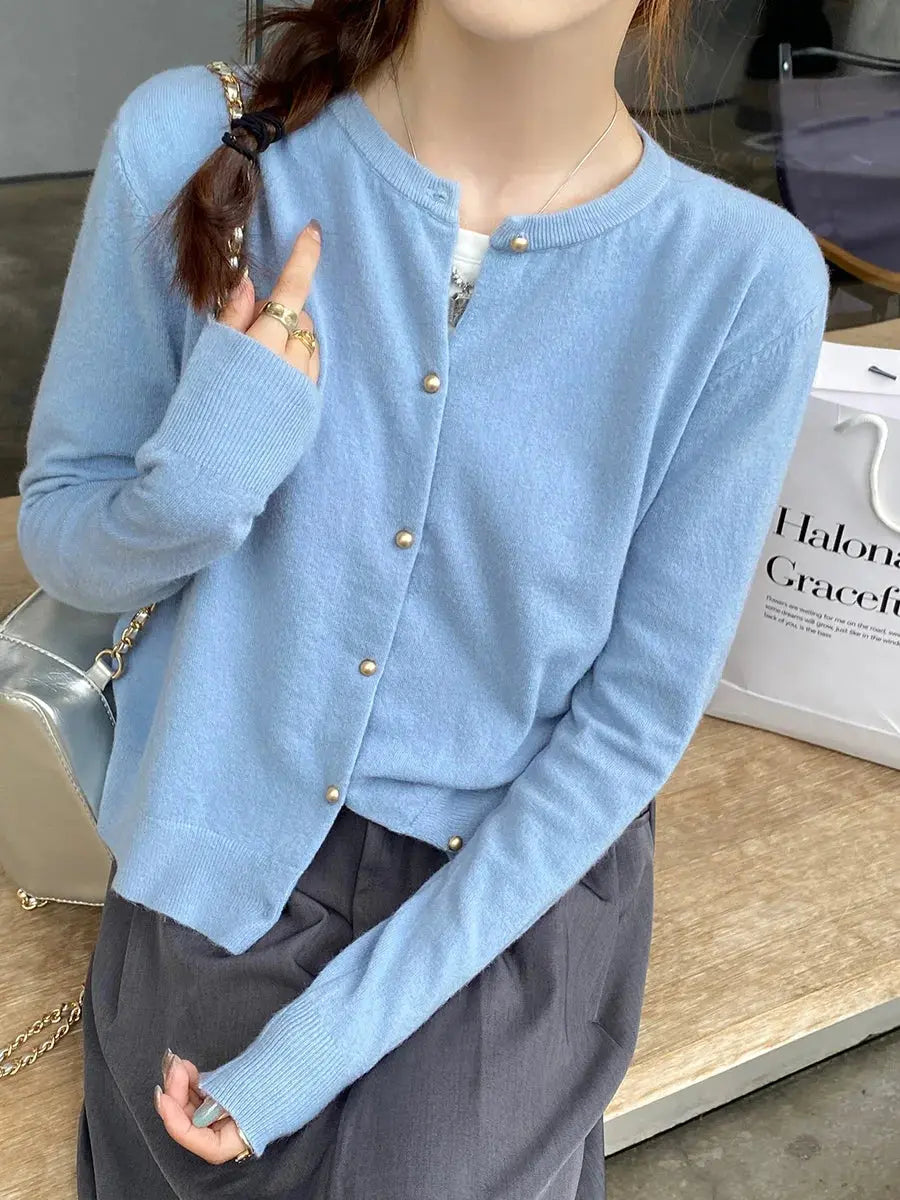 Lightweight cardigan in pastel pink, perfect for spring layering.