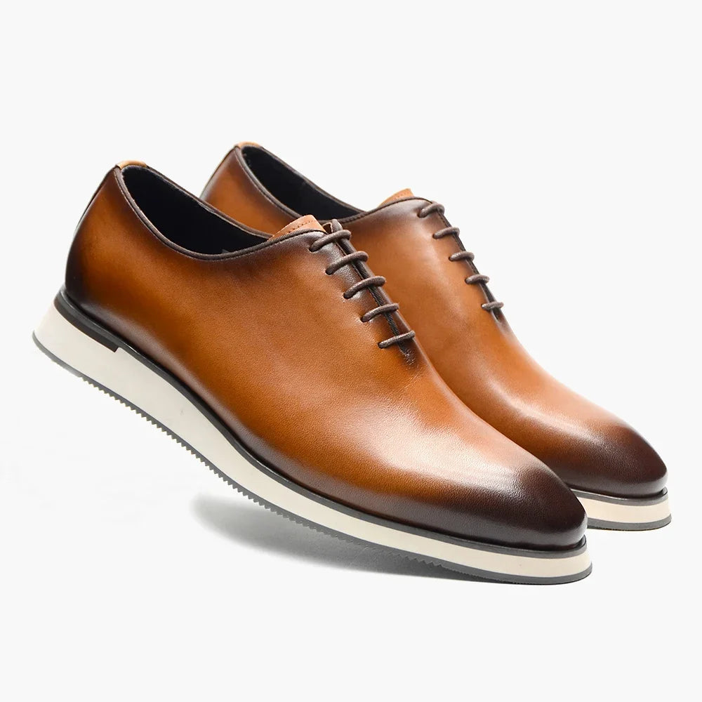 Handmade black cowhide Oxford dress shoes with whole-cut design and classic lace-up closure on white background