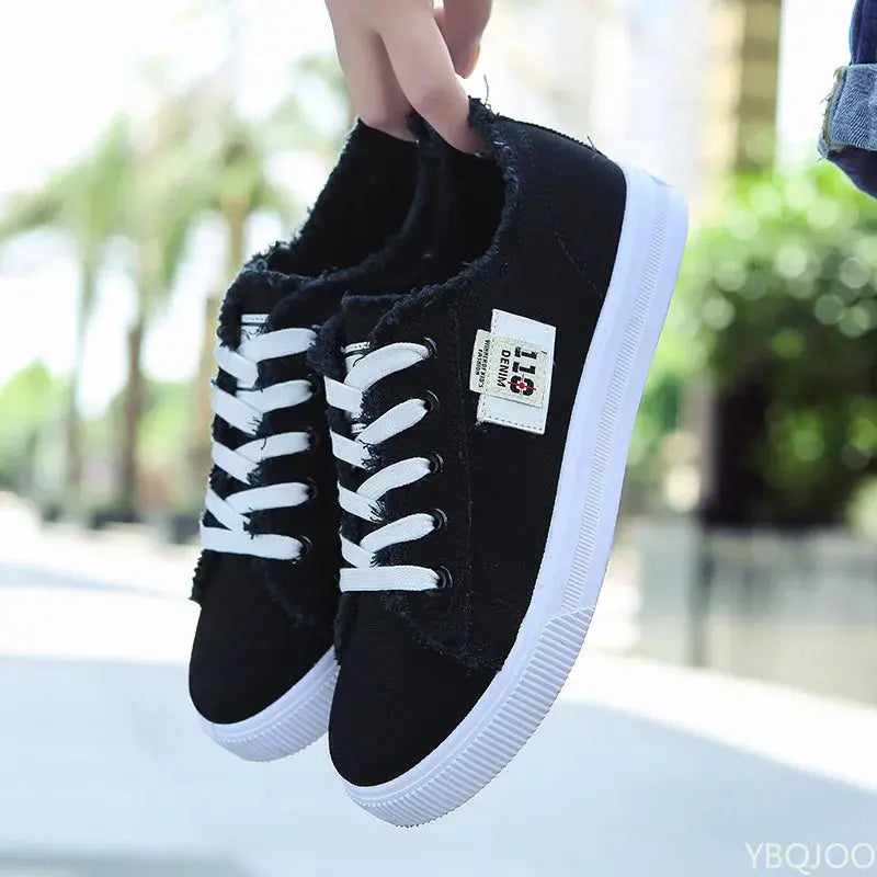 Side view of women's canvas sneakers in black, ideal for spontaneous adventures.