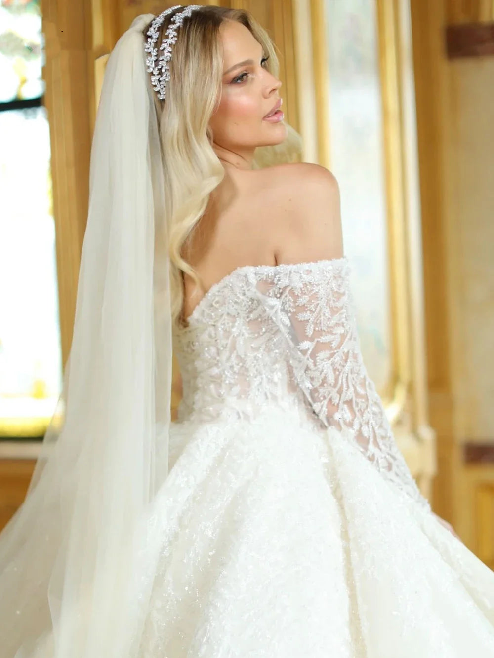 Close-up of hand-embroidered pearls on the Enchanting Elegance Gown, reflecting light beautifully.