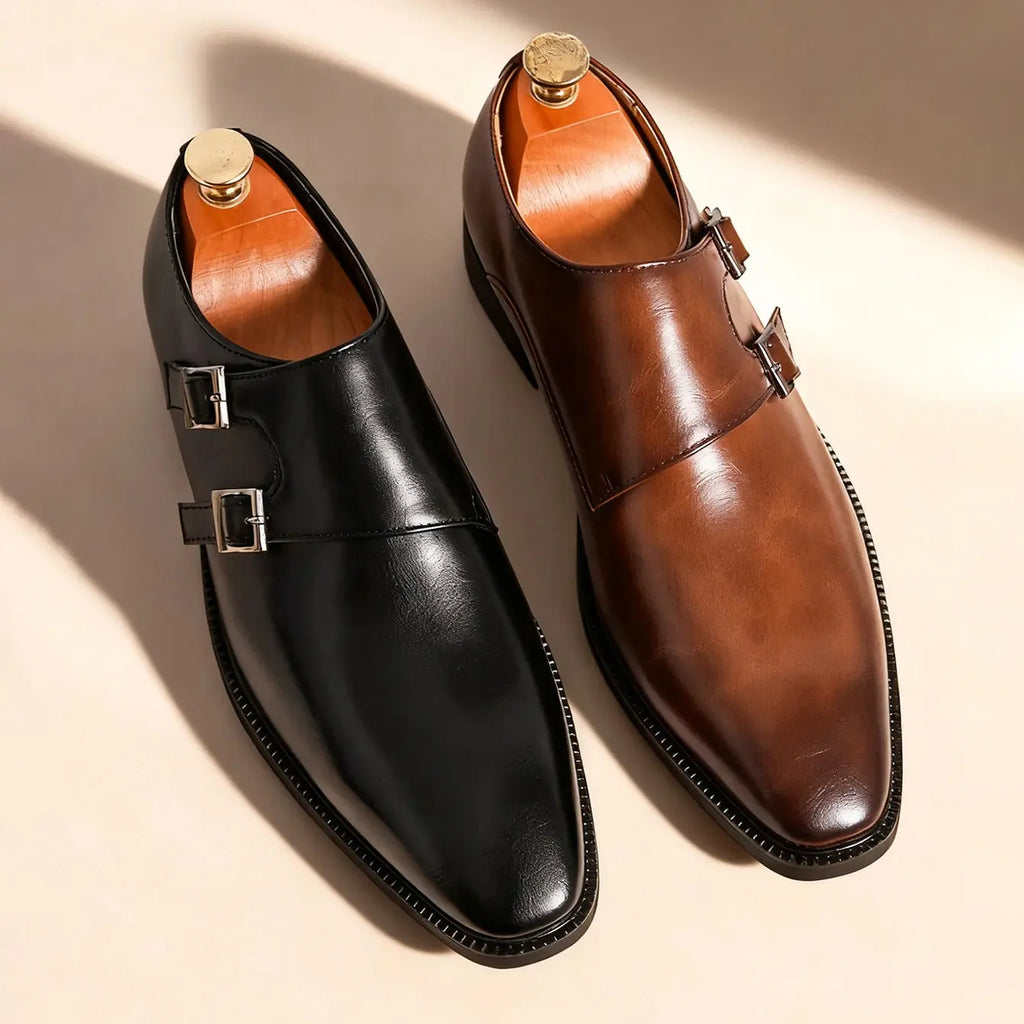 Black monk strap leather shoes with a polished finish and classic buckle design.
