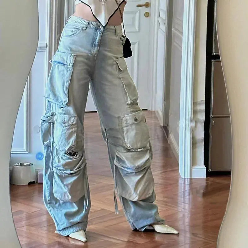 Rebel Spirit Wide-Leg Jeans in faded blue, featuring bold rips and a washed effect.