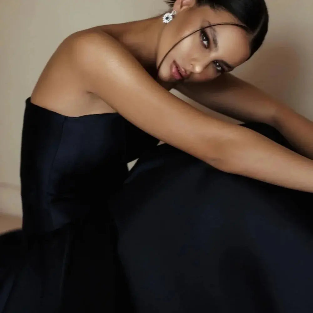 Close-up of luxurious satin fabric of the custom evening gown, highlighting its smooth texture and sheen.
