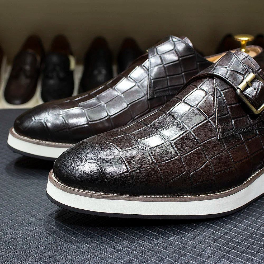 Pair of black crocodile pattern monk strap shoes with double buckle closure and premium leather construction