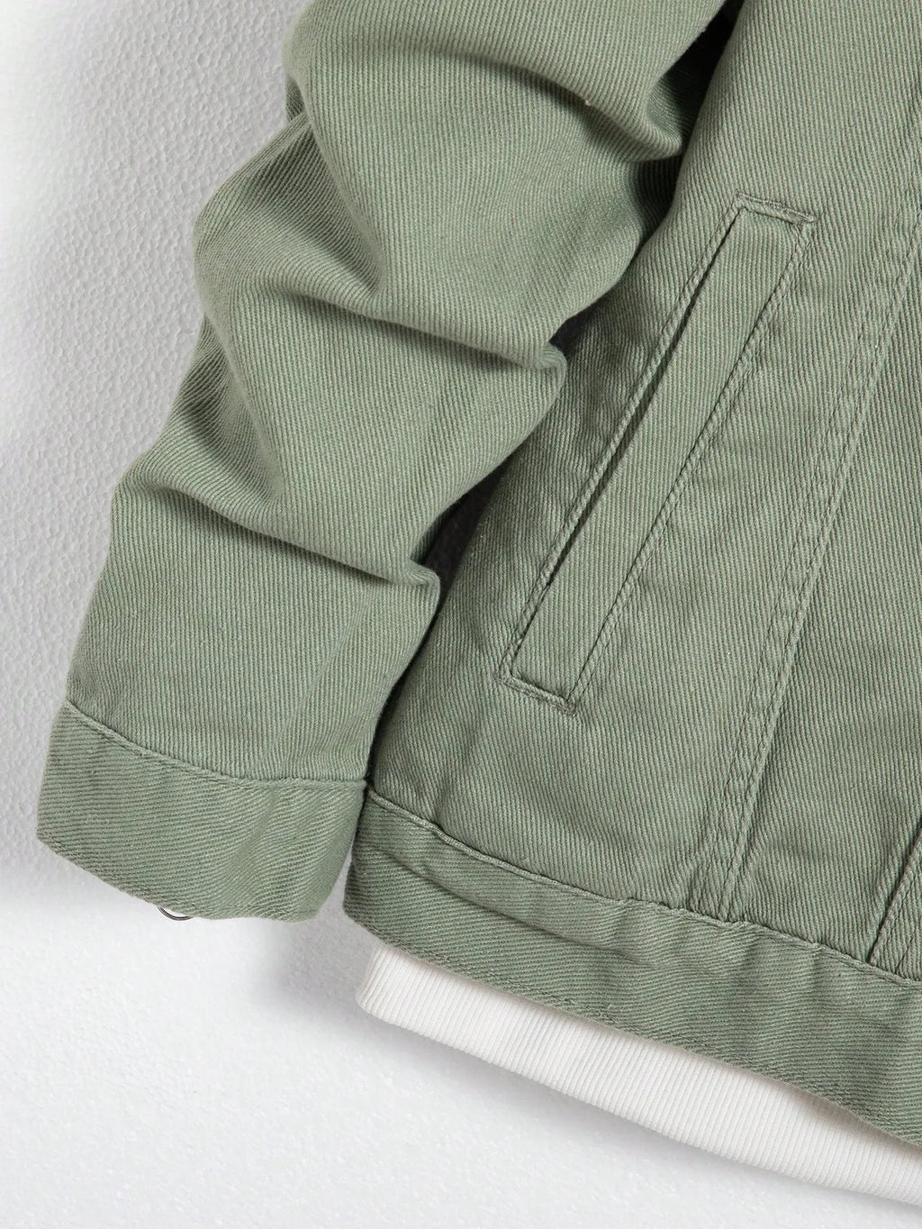 Durable green denim jacket, blending comfort and style effortlessly.