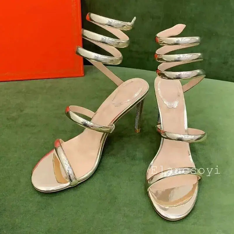 Serpentine Elegance Heels on a runway, showcasing their commanding presence.