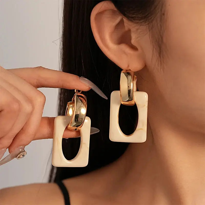 Geometric resin earrings in neutral colors, showcasing a bold and modern design.