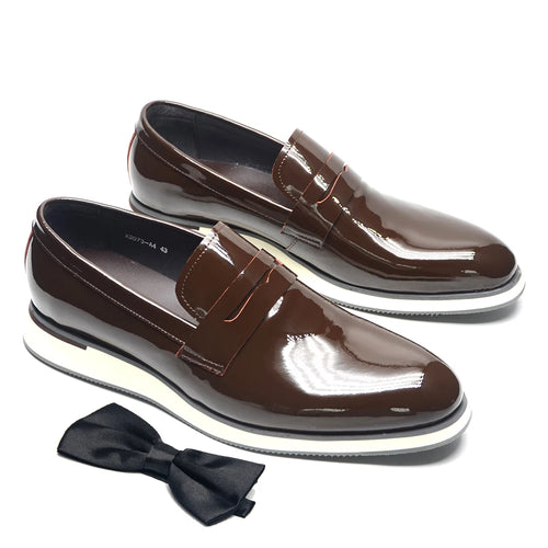 Black patent leather slip-on loafers with glossy finish on white background