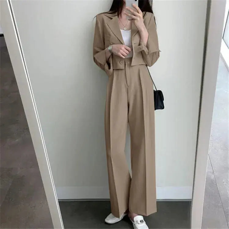 Model adjusting the blazer of the chic wide-leg power suit, ready for a corporate pitch.