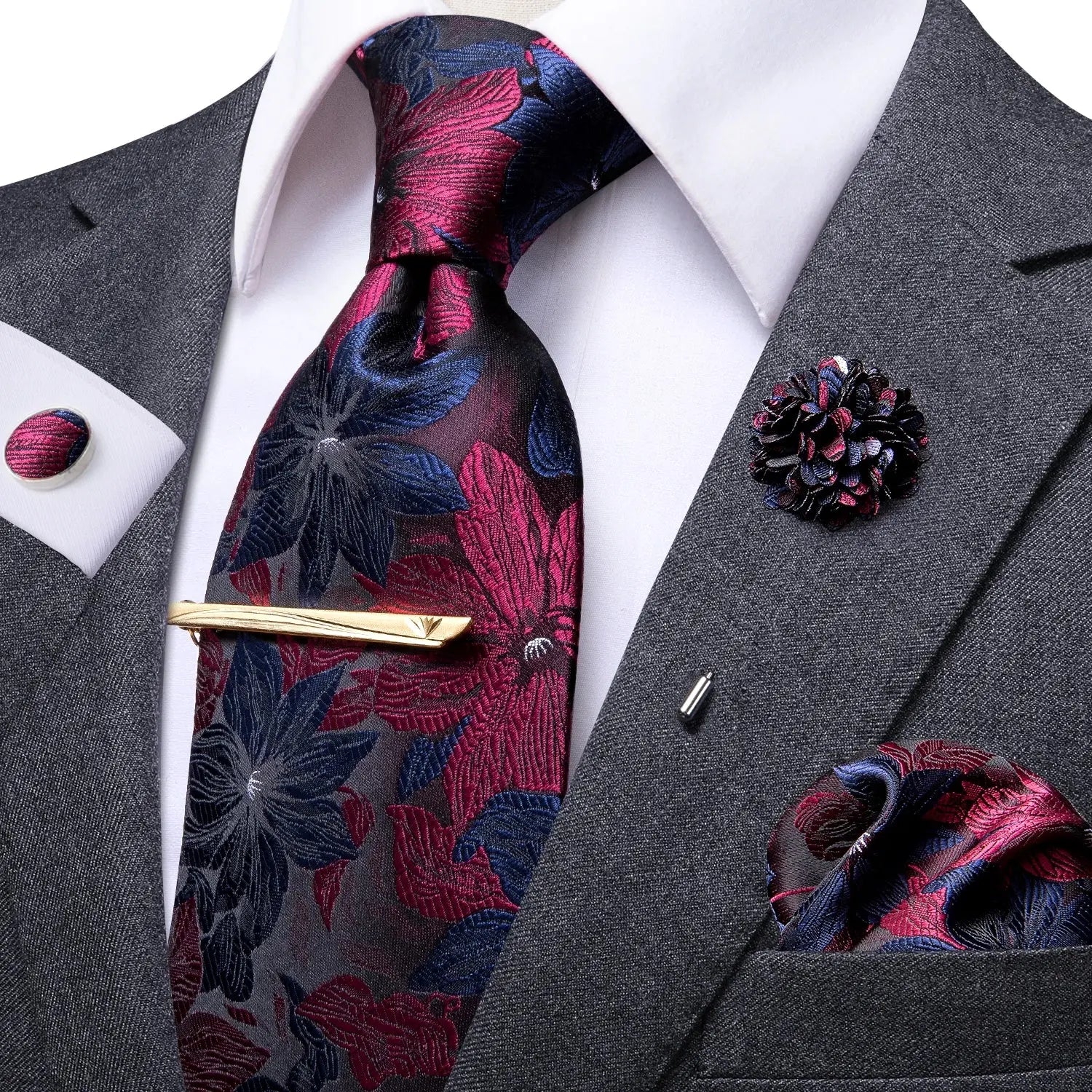 Complete ensemble of tie, cufflinks, and hanky on display.