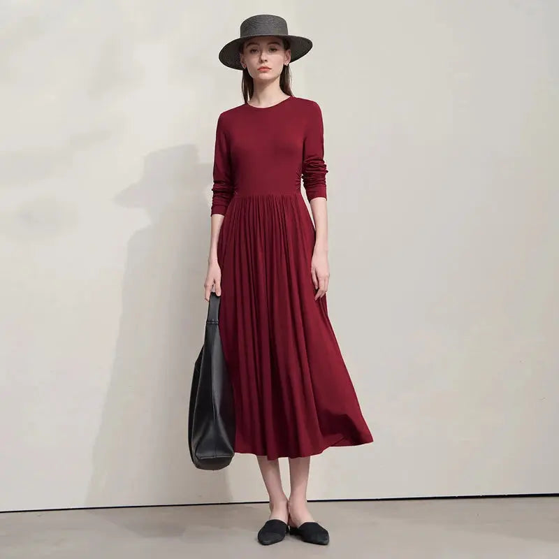 Elegant mid-calf dress showcasing sophisticated folds and a flattering silhouette.
