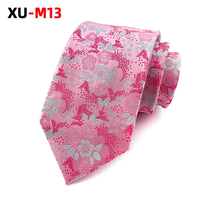 Green jacquard tie laid flat, showcasing its proper fit.