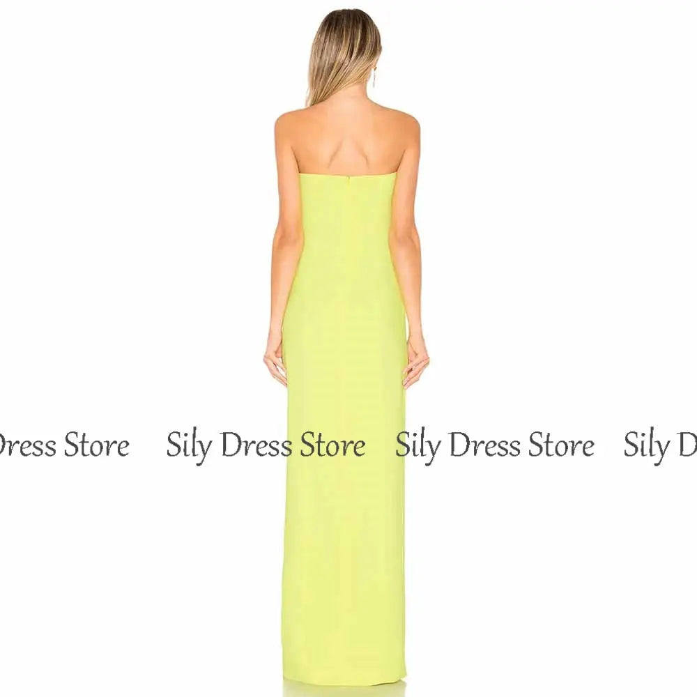Close-up of the emerald gown's strapless neckline, highlighting its elegant silhouette and luxurious fabric.