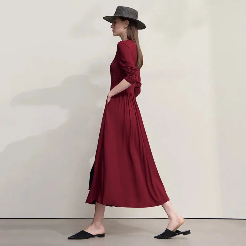 Back view of the slim fit dress highlighting the graceful drape of knitted fabric.