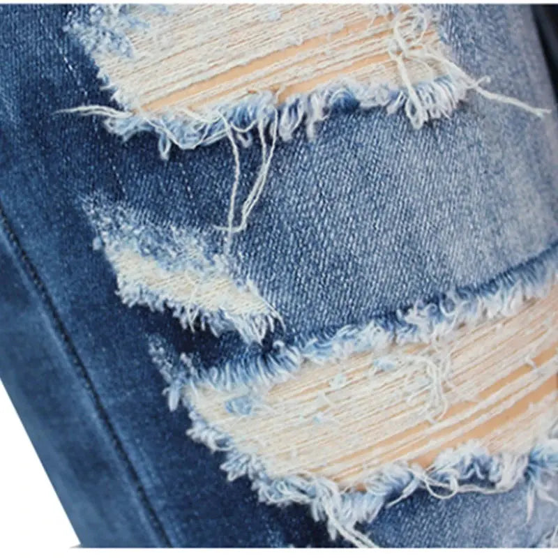 Flat lay of red distressed jeans, perfect for versatile styling with heels or sneakers.
