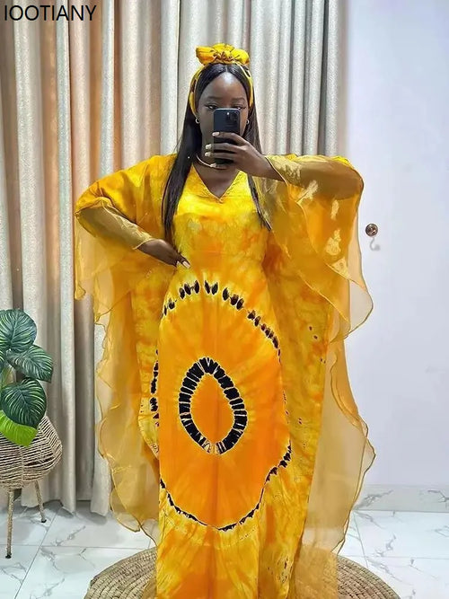 Woman wearing flowing Ankara print kaftan maxi dress with authentic Dashiki-inspired patterns