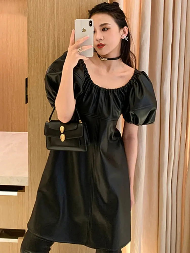 Model in luxe lantern sleeve dress, exuding confidence in a stylish boardroom setting.