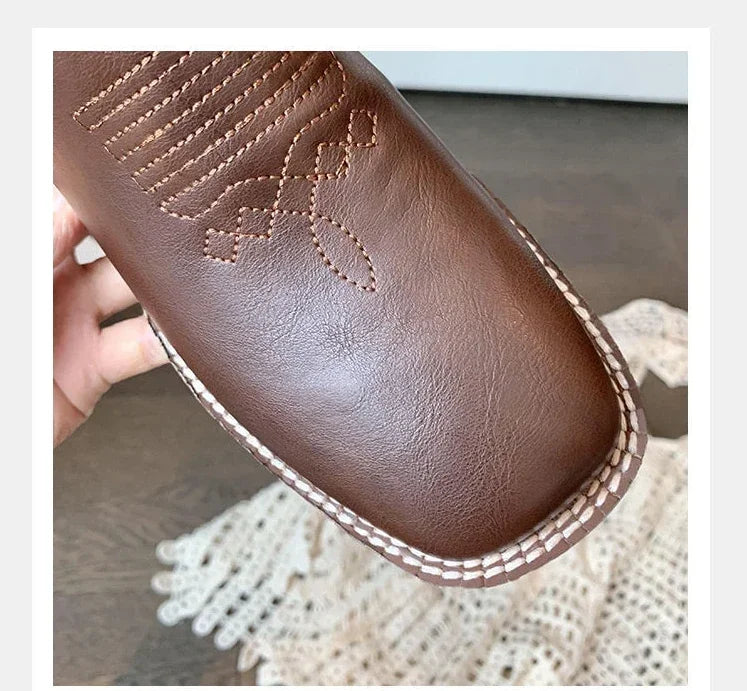 Slip-on cowboy boots with decorative embroidered details and premium leather exterior