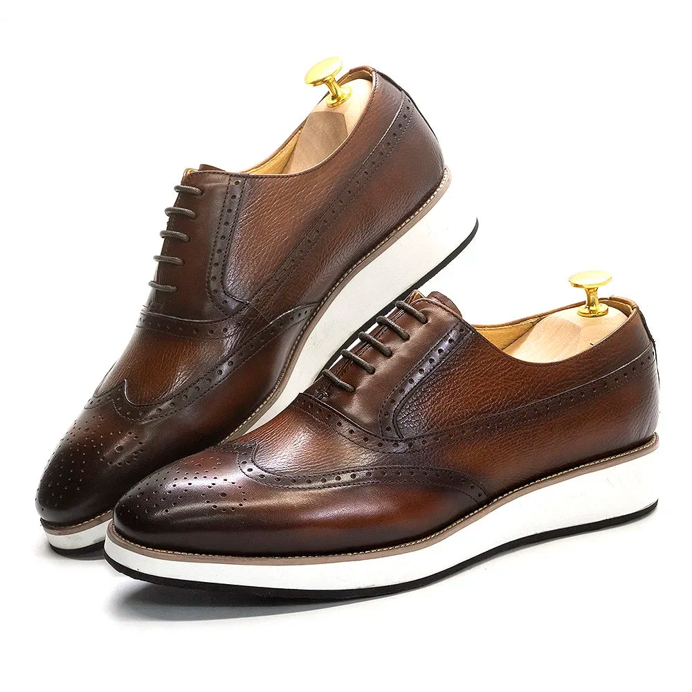 Pair of handmade leather Oxford dress shoes with wing tip brogue detail for men