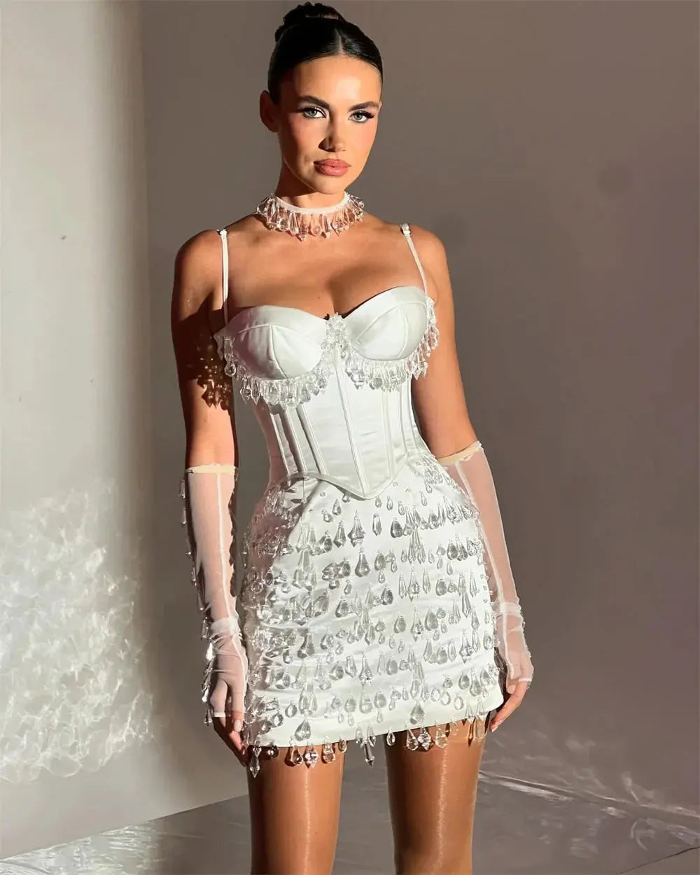 Close-up of light-catching crystals on the luxurious microfiber fabric of the dress.