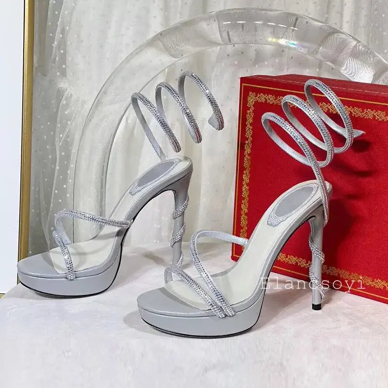 Model wearing black crystal-studded stiletto heels at a gala event.