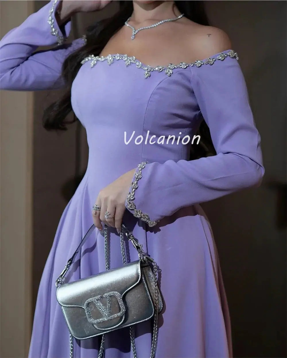 Back view of the off-shoulder gown, displaying the tailored fit and elegant design perfect for formal events.