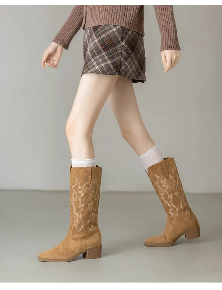 Embroidered cowboy boots paired with denim for downtown adventure outfit