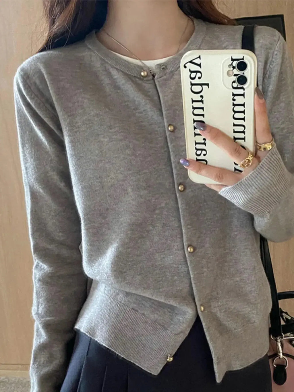 Cozy cardigan in soft beige, crafted from a breathable acrylic-cotton blend.