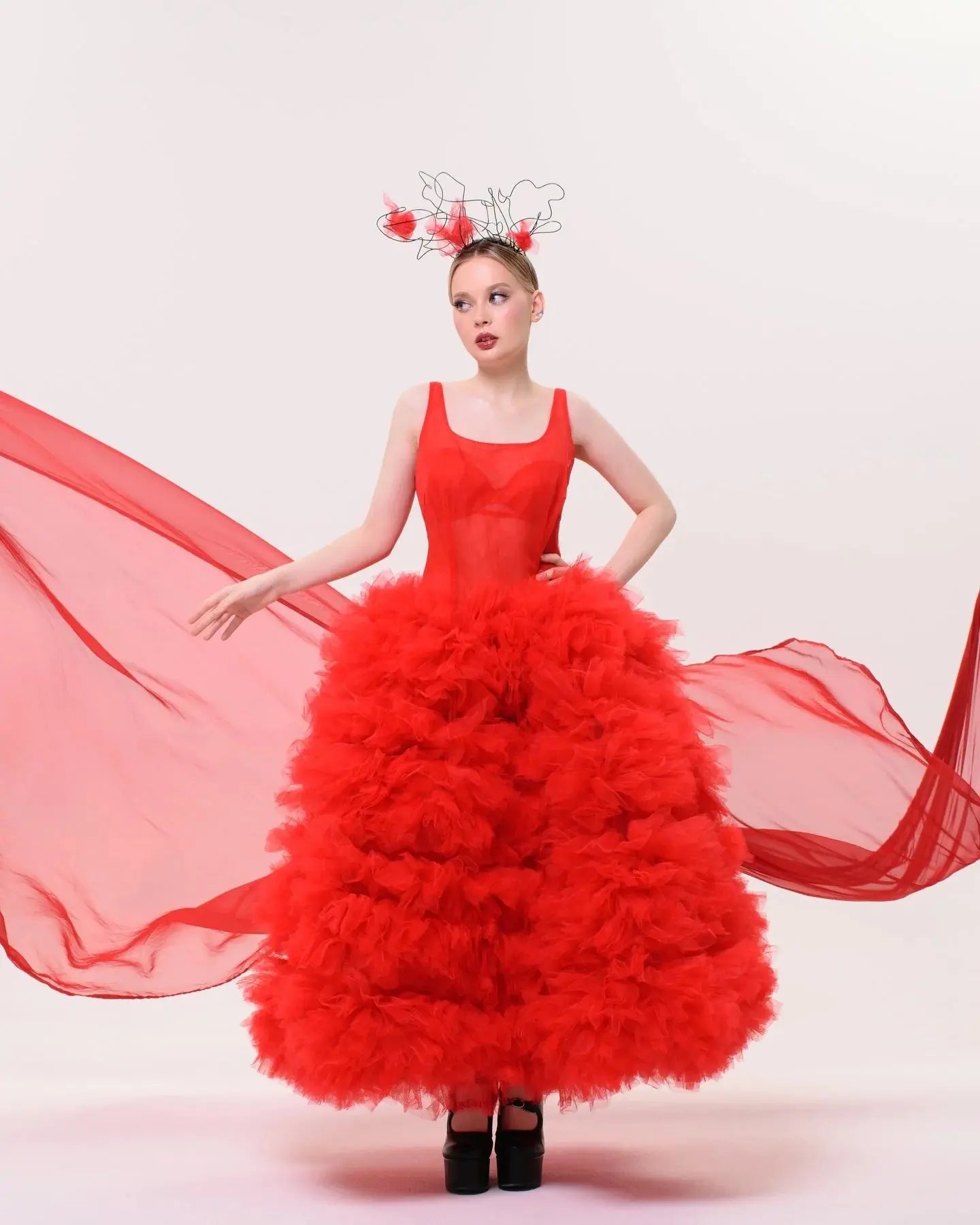 Close-up of soft, feather-light tulle layers in a stunning scarlet dress.