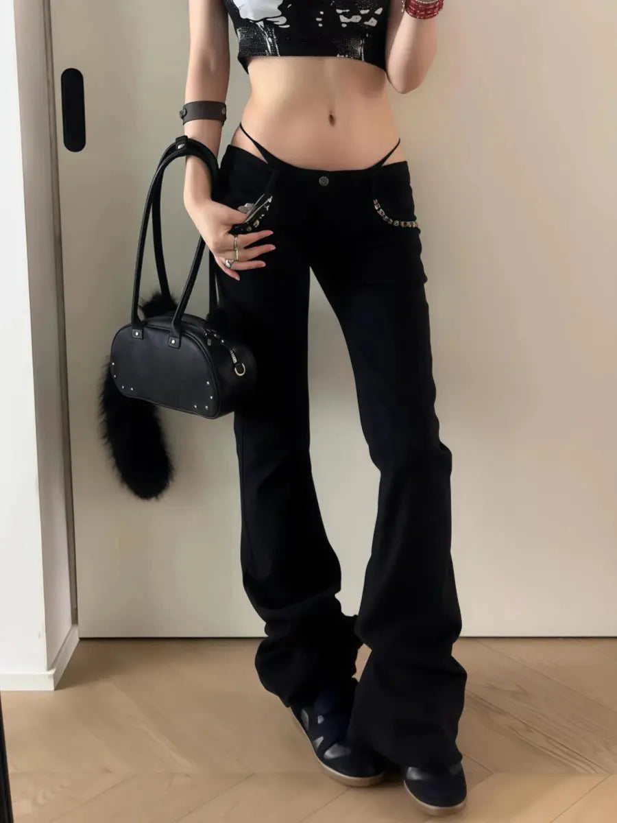 Versatile dark denim flare jeans with dramatic leg-lengthening silhouette and eye-catching metallic rivet details