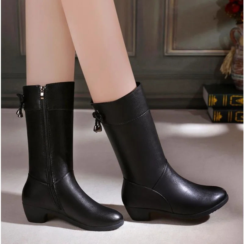 Plush-lined brown leather boots with side zipper shown from three-quarter angle