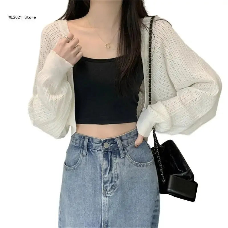 Elegant cropped cardigan in light gray, made from breathable fabric for spring evenings.