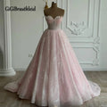 Elegant floor-length gown with hand-sewn pearls and soft tulle, featuring a sweetheart neckline and adjustable lace-up back.