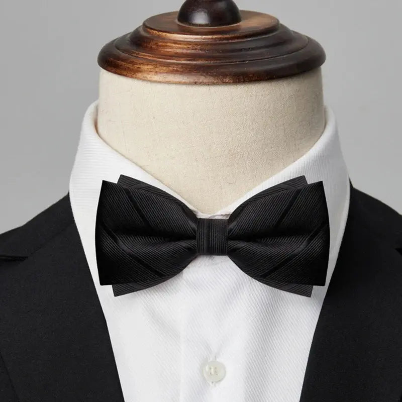 Black bow tie displayed on a formal shirt, highlighting its versatility for events.