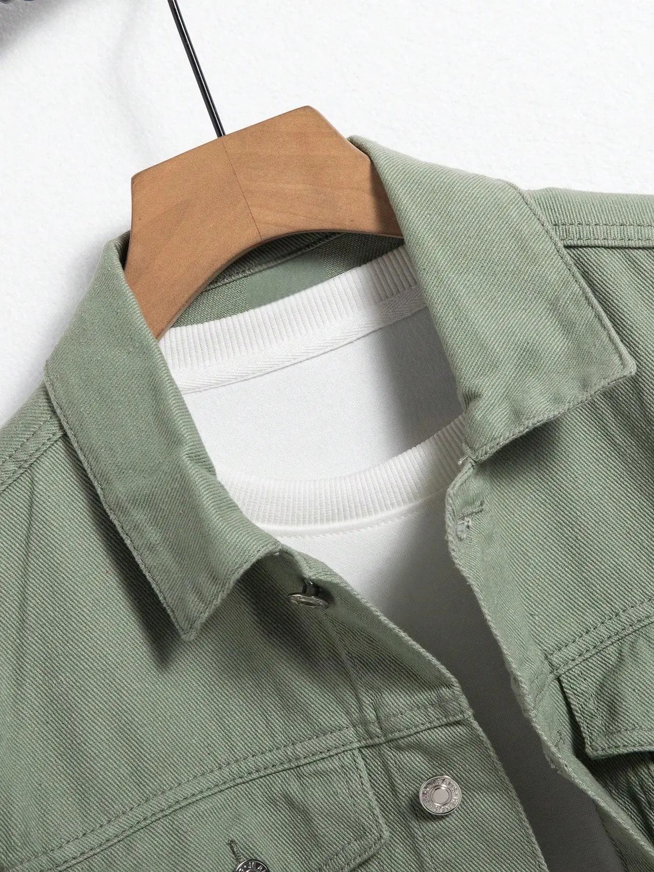 Stylish men's green denim jacket featuring metal buttons and structured fit.