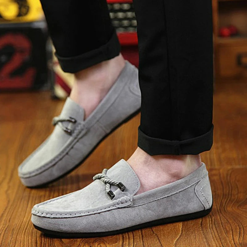 Elegant grey loafers designed for both business and casual occasions, featuring a sleek silhouette.