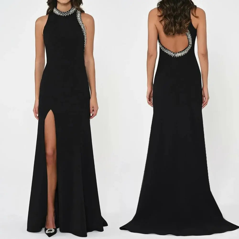 Elegant black halter gown with pleated neckline and subtle beading for a sparkling effect.