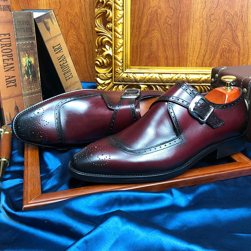 Brown suede monk strap leather shoes with horse-bit buckle and rubber sole on white background