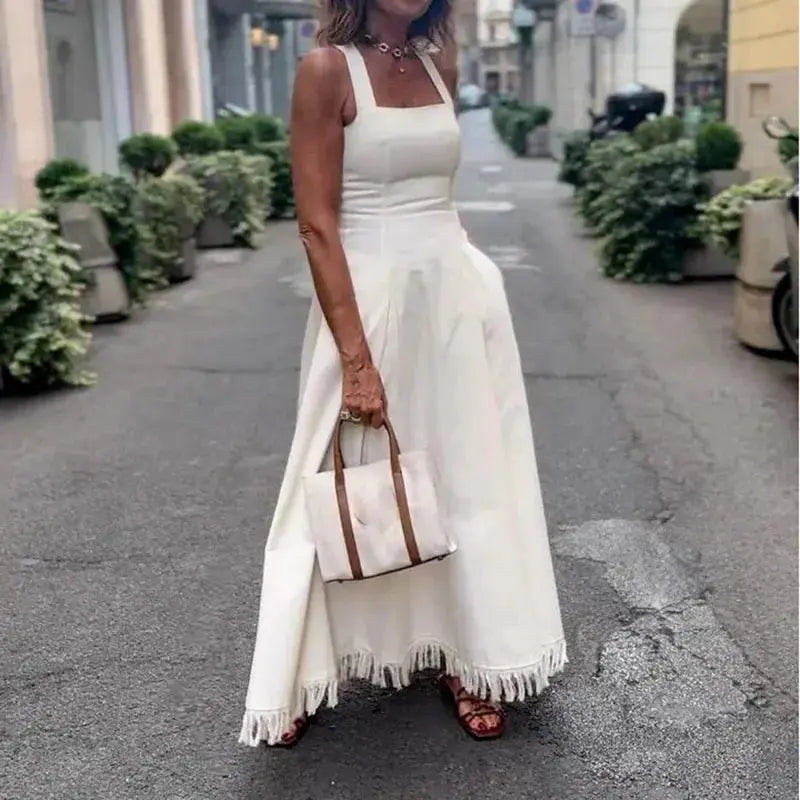 Flowing silhouette of the Summer Breeze Off-Shoulder Dress showcasing tassel details.