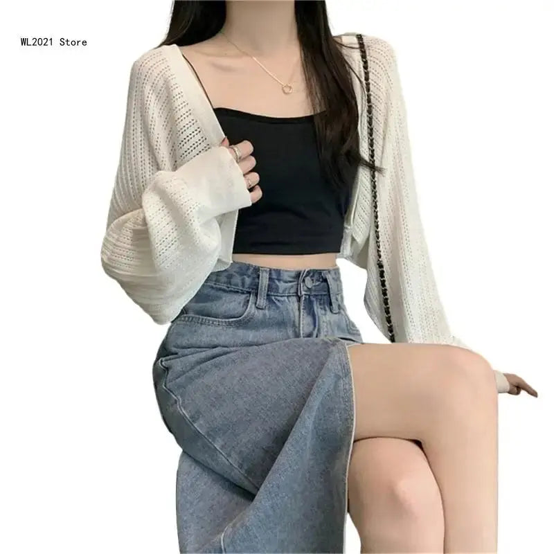 Chic black cropped cardigan with a modern silhouette, ideal for casual or formal gatherings.