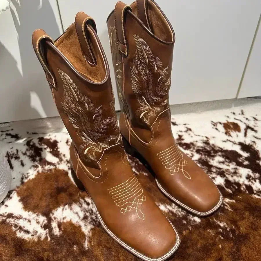 Brown cowboy boots featuring artisan embroidery details and timeless Western charm