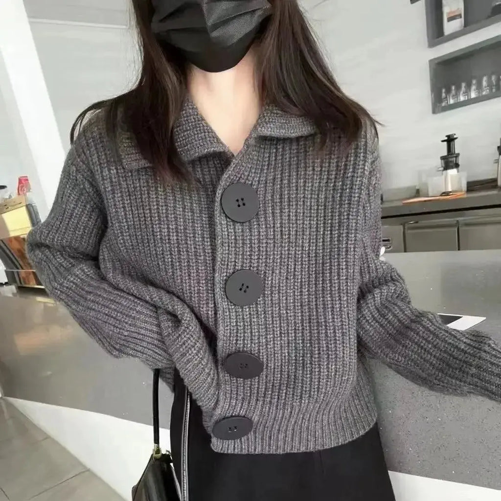 Autumn Whispers Cardigan displayed on a hanger, emphasizing its single-breasted design.