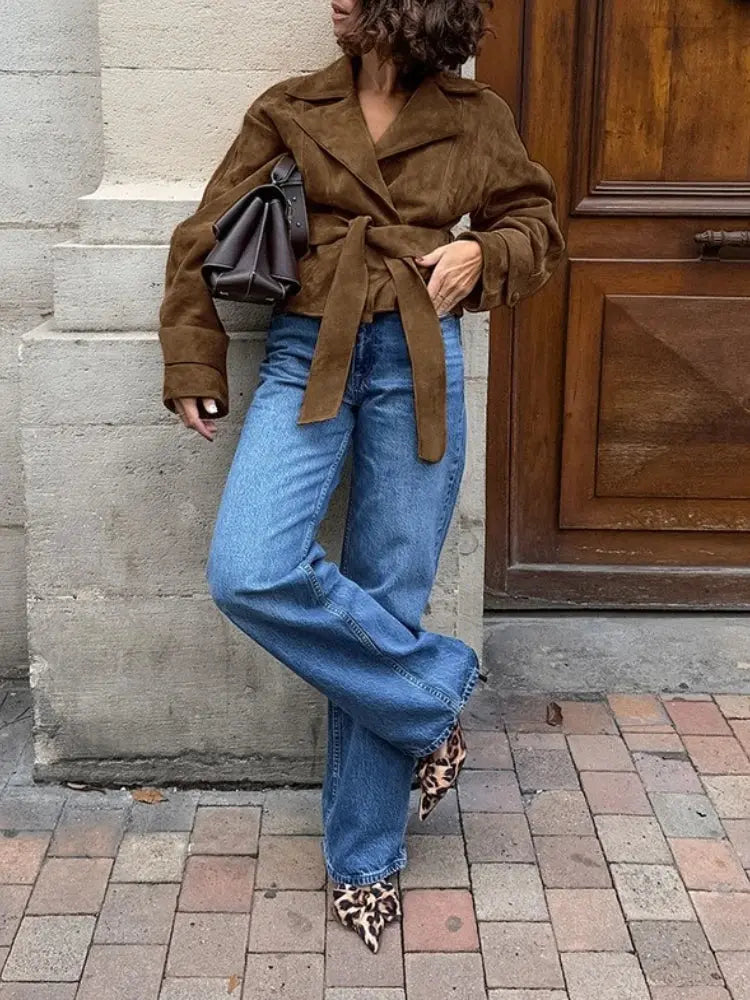 French suede jacket displayed on a hanger, illustrating its versatile design for casual and formal wear.