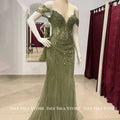 Enchanting Gala Gown in rich green with off-the-shoulder design and mermaid silhouette.